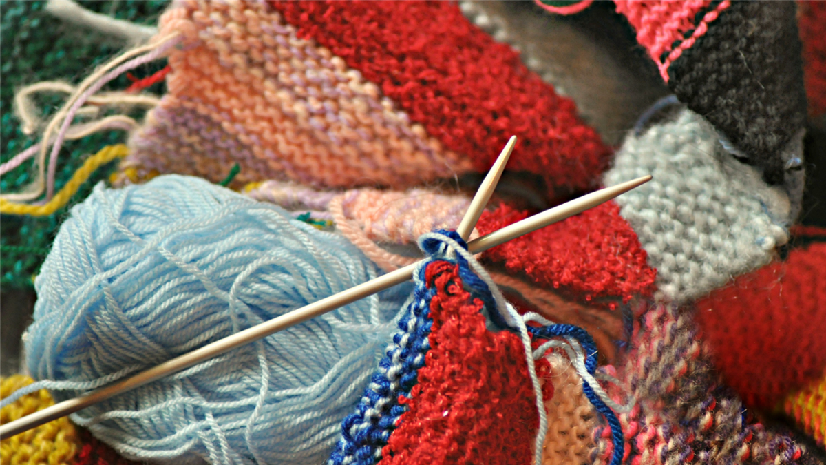 Bilde av strikketøy og garn i forskjellige farger - Klikk for stort bilete